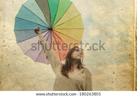 Woman with umbrella. Photo in old color image style.