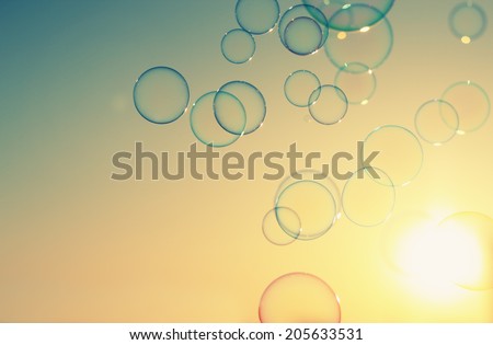 Soap bubbles floating in the air as the Summer sunsets