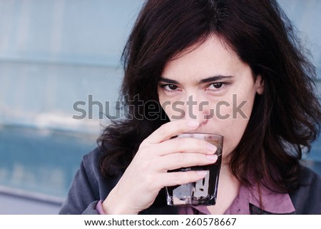 Portrait of beautiful 35 years old woman drinking coffee