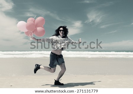 beautiful woman holding red balloons