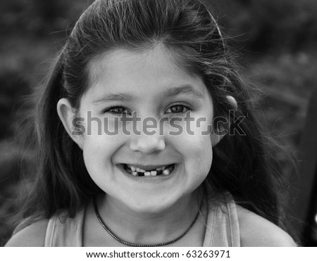 Smile of small toothless girl black and white photo