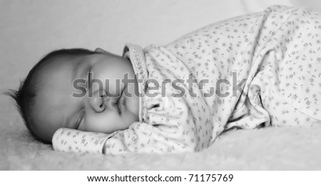 monthly baby sleeps on a white blanket