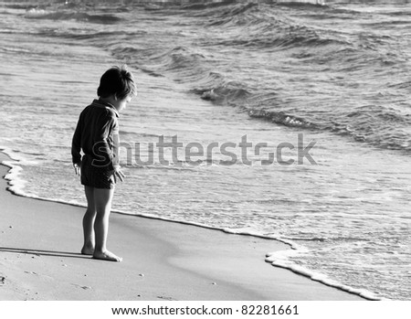 child at the sea, black and white shoot