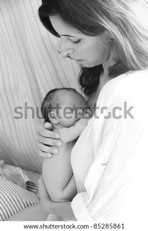 35-year-old beautiful mom is holding her newborn daughter