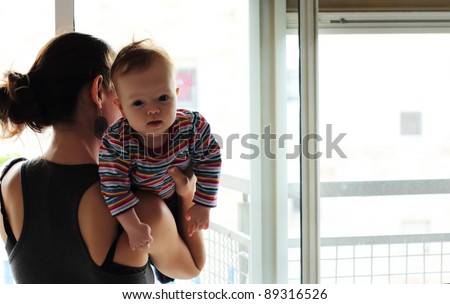 mother with her baby near the window