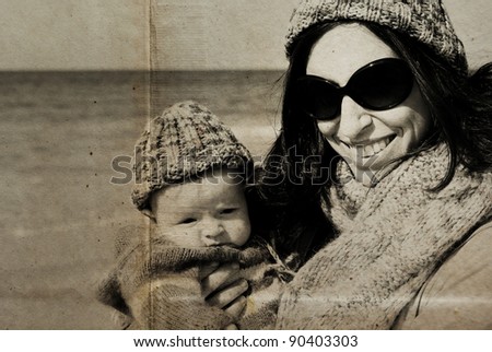 mother with her child on the beach. Photo in old image style.