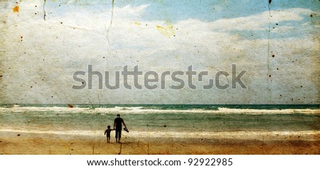 father and son playing together on the beach. Photo in old image style.