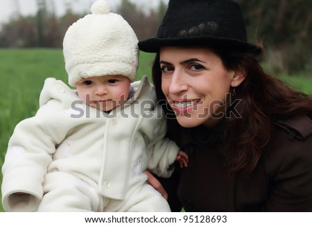 mother and child walking in the park on a cloudy day