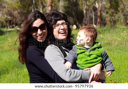 two beautiful girls with a baby in the background of the spring forest