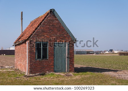 Dilapidated old barn in a Dutch landscape.
