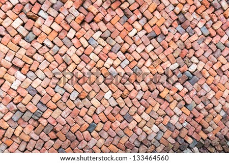 Loosely stacked brick wall at an old brick factory in Belgium. All baked from the same clay but still not identical.