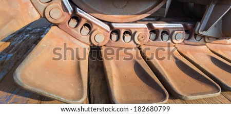 Rusty steel caterpillar tracks for vehicle propulsion at close.