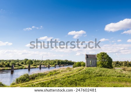 Small building in a picturesque landscape on a sunny day  in summertime.