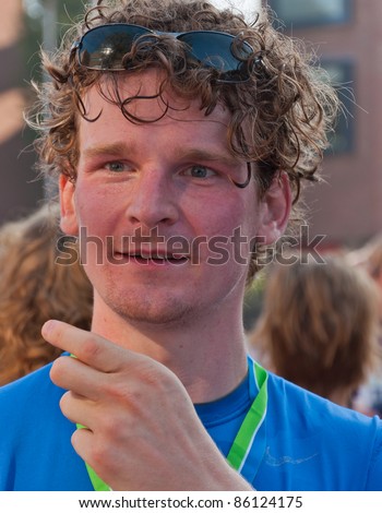 BREDA, NETHERLANDS – OCT. 2: Singelloop (Canal Run), A young sweaty and happy runner shortly after the finish of the yearly Singelloop in the Dutch city of Breda in the Netherlands on October 2, 2011.