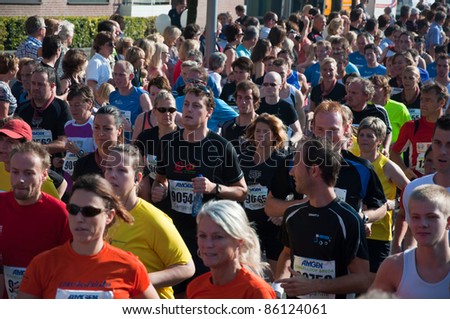 BREDA, NETHERLANDS – OCT. 2: Singelloop (Canal Run), Closeup of runners shortly after the start of the 10 km run of the Singelloop in the Dutch city of Breda in the Netherlands on October 2, 2011.