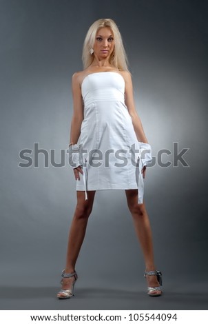 Beautiful sexual girl blonde pose on gray background