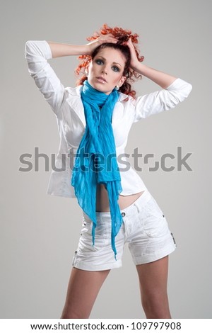 Beautiful girl model with red hair pose on light gray background