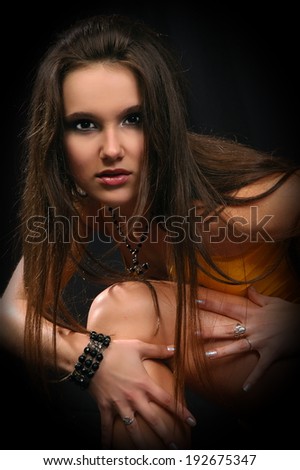 Beautiful sexual girl model in erotic cloth pose on black background