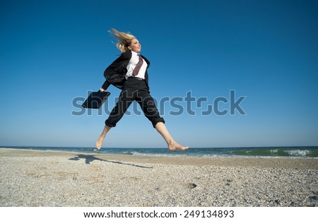 Concept illustrating the desire to achieve results, a business woman running on the beach