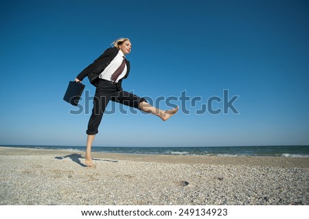 Concept illustrating the desire to achieve results, a business woman running on the beach