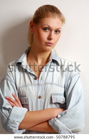 Portrait of the beautiful sexual girl to models in shirt on light background