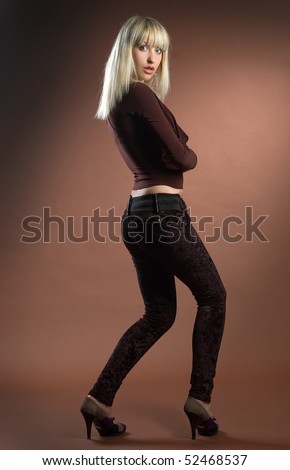 Beautiful sexual high-heeled girl on brown background