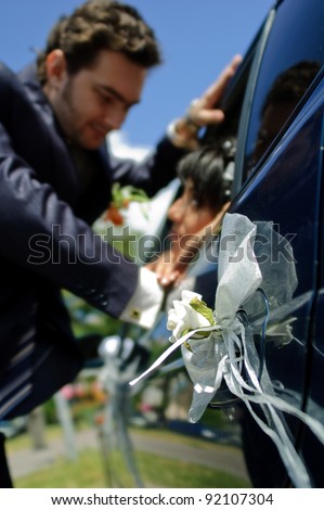 Decoration on handle door wedding car on background pair(vapour)s newlyweds
