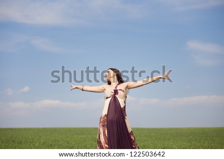 young happy woman in green field