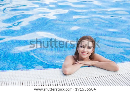 Beautiful woman in hotel swimming pool