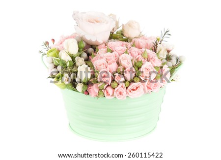 bouquet of bright red roses in a bucket on a white background