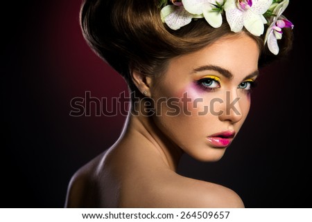 Portrait of a beautiful woman with orchids flower in her hair.