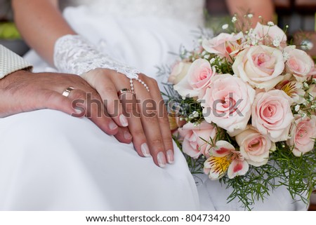 stock photo Hands and rings with wedding bouquet