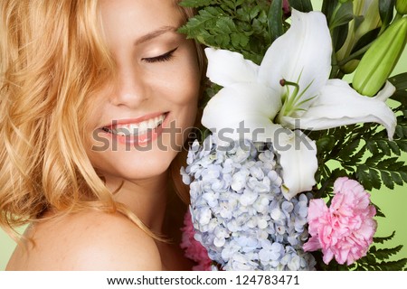 Portrait of attractive woman with flower smiling