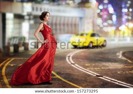 Young Beauty Famous Woman In Fluttering Red Dress Outdoor