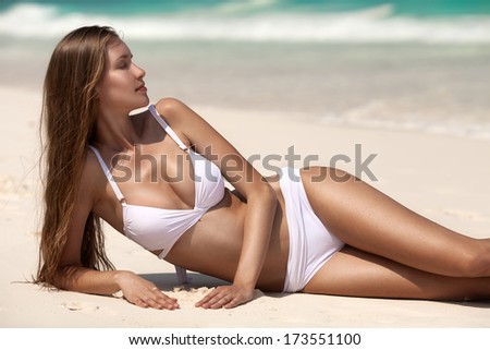 Young Woman Sunbathing At Tropical Beach