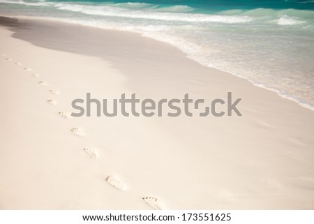 White beach, azure sea, waves and footsteps on perfect snow-white sand.