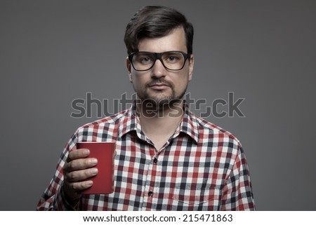 Handsome hipster modern man and cup of coffee in hand.