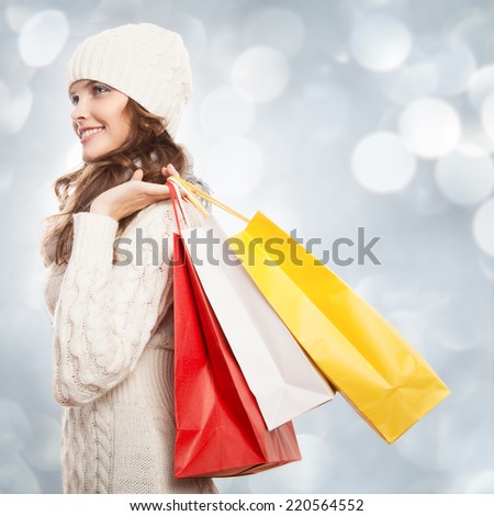 Shopping happy woman holding bags. Winter sales.