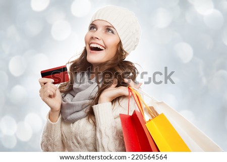 Shopping happy woman holding bags and credit card. Winter sales.