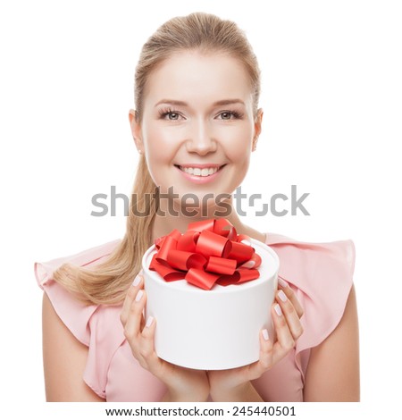 Young happy smiling woman with a gift in hands. Isolated on white background.