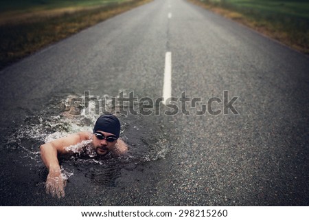 Strong Man Swim On Asphalt Road