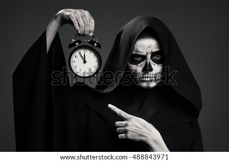 Scary Death Hold A Watch In His Hand. Realistic Skull Makeup.
