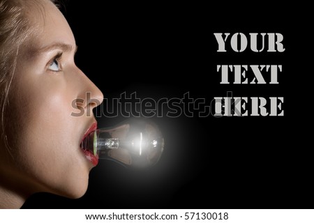 young woman with light bulb in the mouth over black