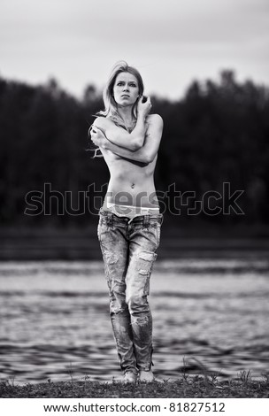young sexy woman in jeans at the river. W/B Image