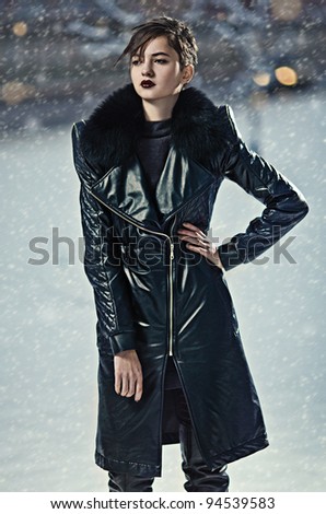 Stylish brunette woman in leather coat