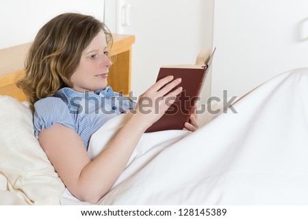woman read a book in a bed