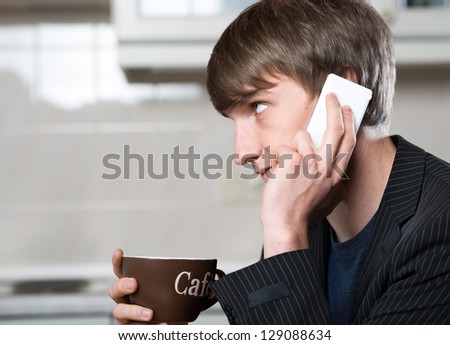 young business man drink a cup of coffee in the kitchen
