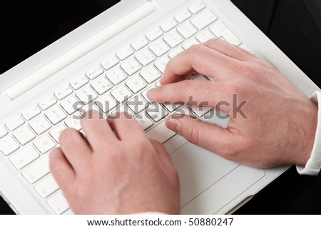 man typing on a computer keyboard