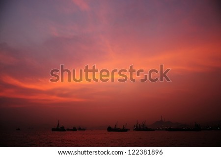 Burning Sky over the sea with some boat on the surface