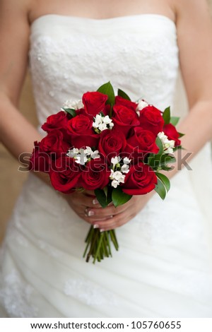 Beautiful bouquet made of roses in the hands of a bride
